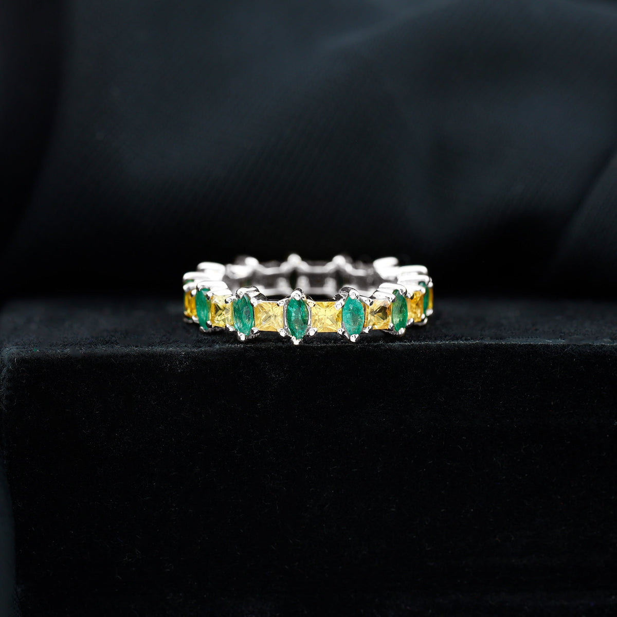 Designer yellow sapphire and emerald eternity wedding ring by Rosec Jewels featuring alternating gemstones in a gold band
