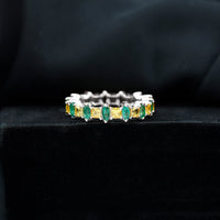 Designer yellow sapphire and emerald eternity wedding ring by Rosec Jewels featuring alternating gemstones in a gold band