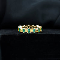 Gold eternity wedding band by Rosec Jewels featuring yellow sapphire and emerald gemstones in a continuous circle design
