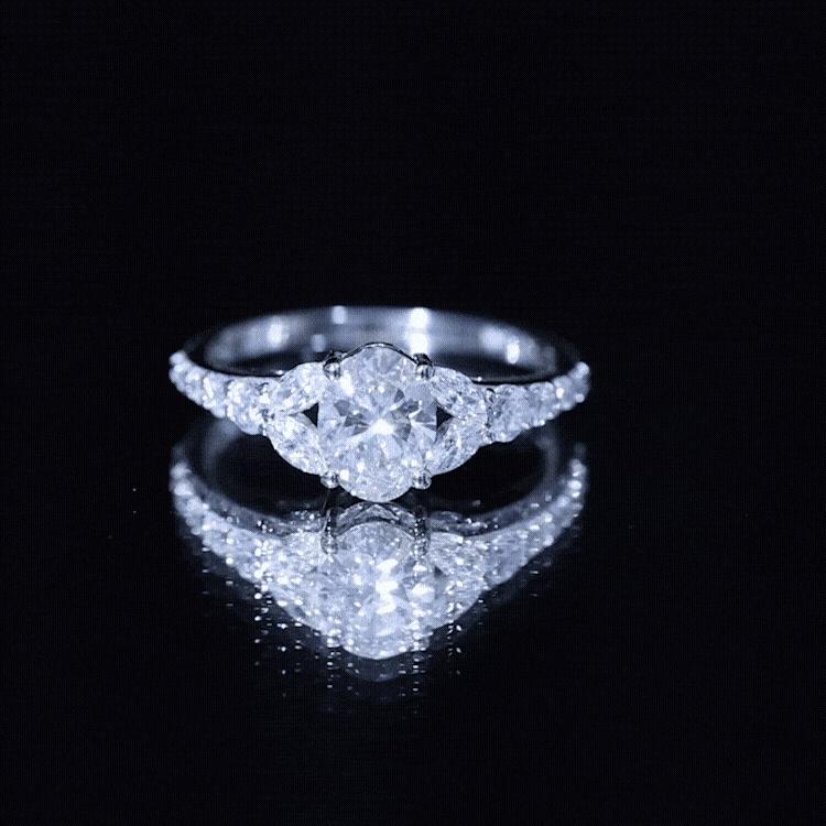 Certified 1 Carat Oval Lab Grown Diamond Engagement Ring with side stones, featuring a yellow gold band.