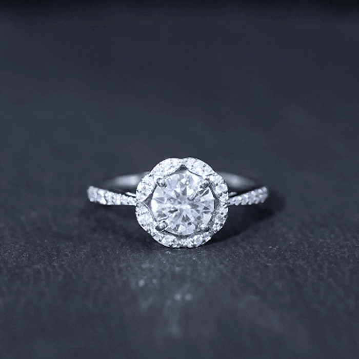 Yellow gold lab-grown diamond halo engagement ring with a 7mm center stone, featuring intricate detailing and sparkling accents.