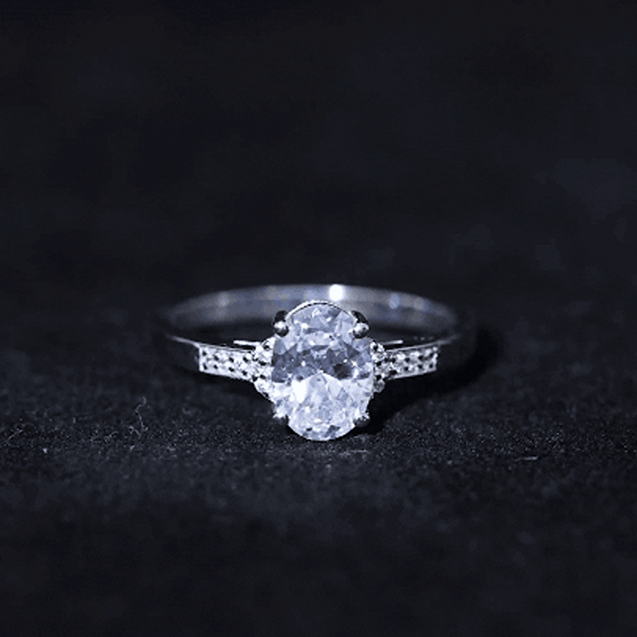 Yellow gold oval lab-grown diamond solitaire engagement ring with 6x8mm center stone and elegant band design.