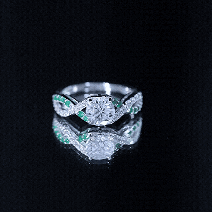 Lab grown diamond crossover engagement ring with emerald accents, yellow gold band, by Rosec Jewels, showcasing intricate design.