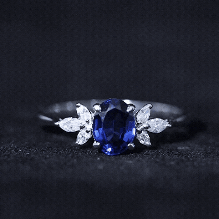Yellow gold 1.5 carat lab-grown blue sapphire oval engagement ring with diamond trio by Rosec Jewels.