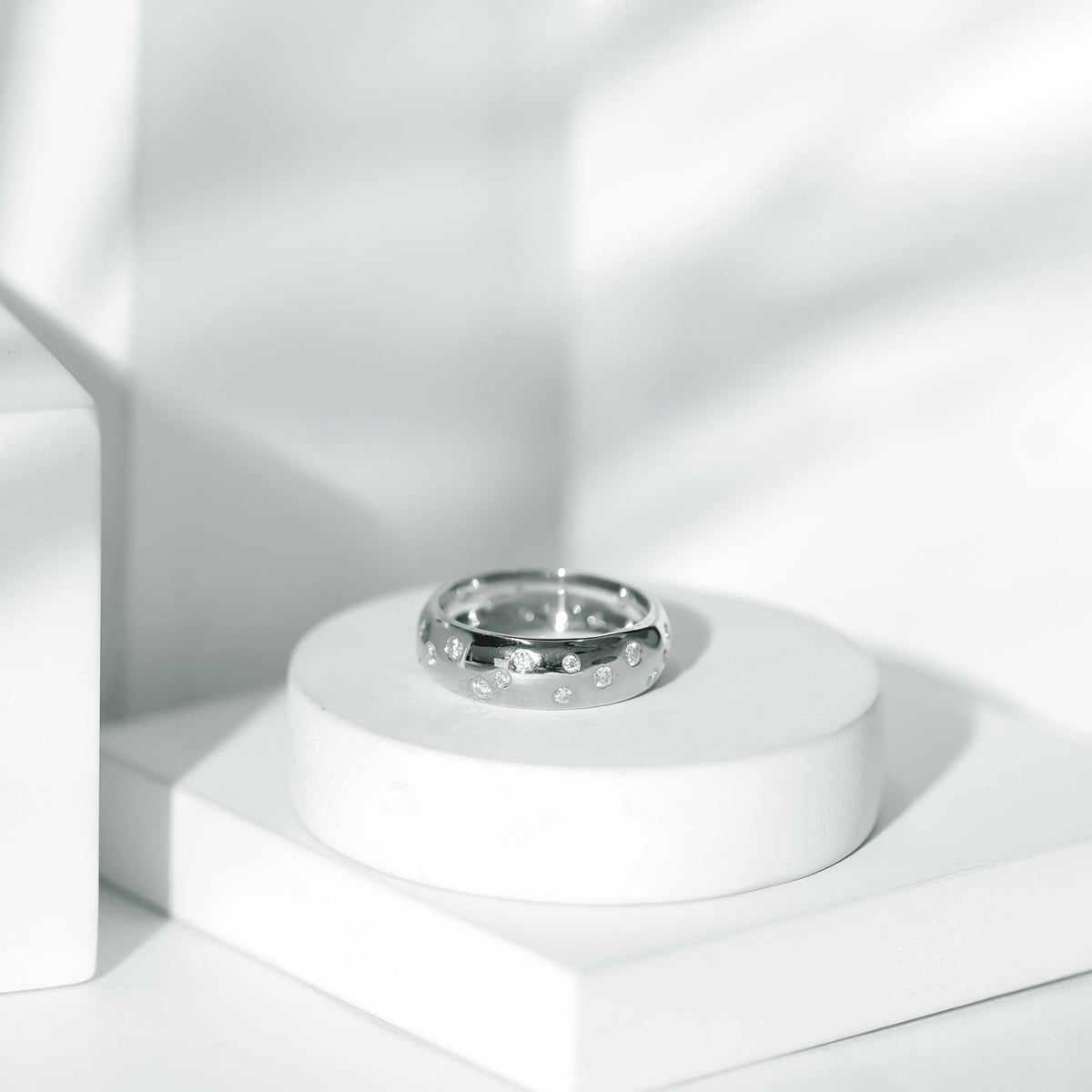 Wide band ring with scatter moissanite stones, showcasing a sparkling wedding ring design by Rosec Jewels.