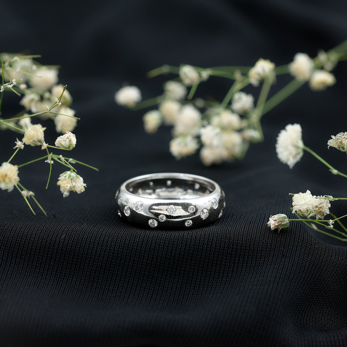 Wide band ring with scattered moissanite stones from Rosec Jewels, showcasing a sparkling, elegant wedding ring design.