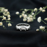 Wide band ring with scattered moissanite stones from Rosec Jewels, showcasing a sparkling, elegant wedding ring design.