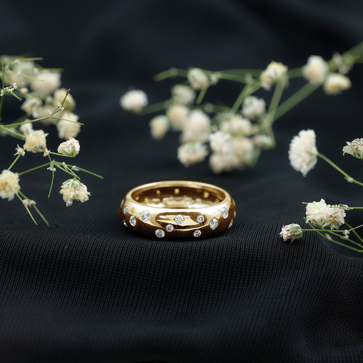 Rosec Jewels scatter moissanite wide band wedding ring with sparkling stones and intricate design, shown on a plain background.