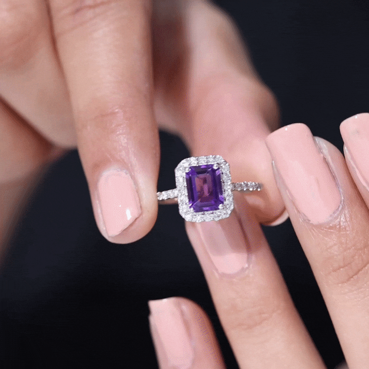 Yellow gold 1.4 carat emerald cut amethyst engagement ring with diamond halo, featuring intricate details and a sparkling gemstone.