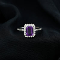 Amethyst emerald cut engagement ring with diamond halo from Rosec Jewels, featuring a 1.4 carat purple gemstone and sparkling accents