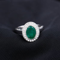 1.2 Carat Oval Lab Grown Emerald Bezel Set Engagement Ring With Diamond Halo