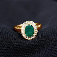 1.2 Carat Oval Lab Grown Emerald Bezel Set Engagement Ring With Diamond Halo