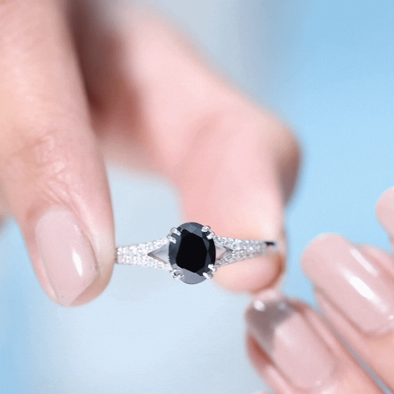 Oval lab-grown black and white diamond engagement ring with split shank by Rosec Jewels, showcasing sparkling gemstones and elegant design.