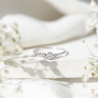 Rosec Jewels minimal diamond promise ring with bezel setting, showcasing a sleek band and sparkling diamond detail.