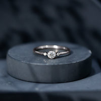 Minimal diamond promise ring in bezel setting by Rosec Jewels, showcasing a sleek design with a sparkling diamond centerpiece.