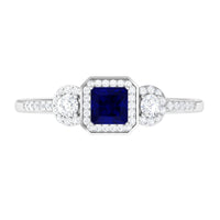 Rosec Jewels blue sapphire engagement ring with princess cut sapphire and diamond accents on a silver band.