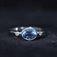 Bezel set aquamarine and diamond engagement ring by Rosec Jewels featuring a yellow gold band and east-west design.