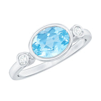 Bezel set aquamarine and diamond engagement ring by Rosec Jewels, featuring a central aquamarine with side diamonds in a sleek ring design.