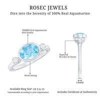Bezel set aquamarine and diamond engagement ring by Rosec Jewels, featuring an east-west design with detailed metalwork.