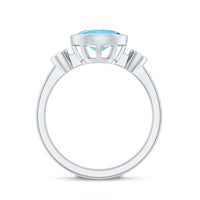 Bezel set aquamarine and diamond engagement ring by Rosec Jewels, featuring a central aquamarine gemstone with side diamonds in a rings setting.