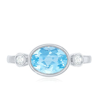 Bezel set aquamarine and diamond engagement ring by Rosec Jewels featuring an east-west design with elegant gemstone accents.