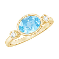 Bezel set aquamarine and diamond engagement ring by Rosec Jewels with an east-west design and elegant silver band.