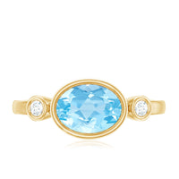Bezel set aquamarine and diamond engagement ring by Rosec Jewels, featuring east-west design with sparkling gemstones.