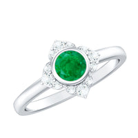 Natural bezel set 5mm emerald flower engagement ring with diamond accents by Rosec Jewels, showcasing intricate floral design and gemstone details.