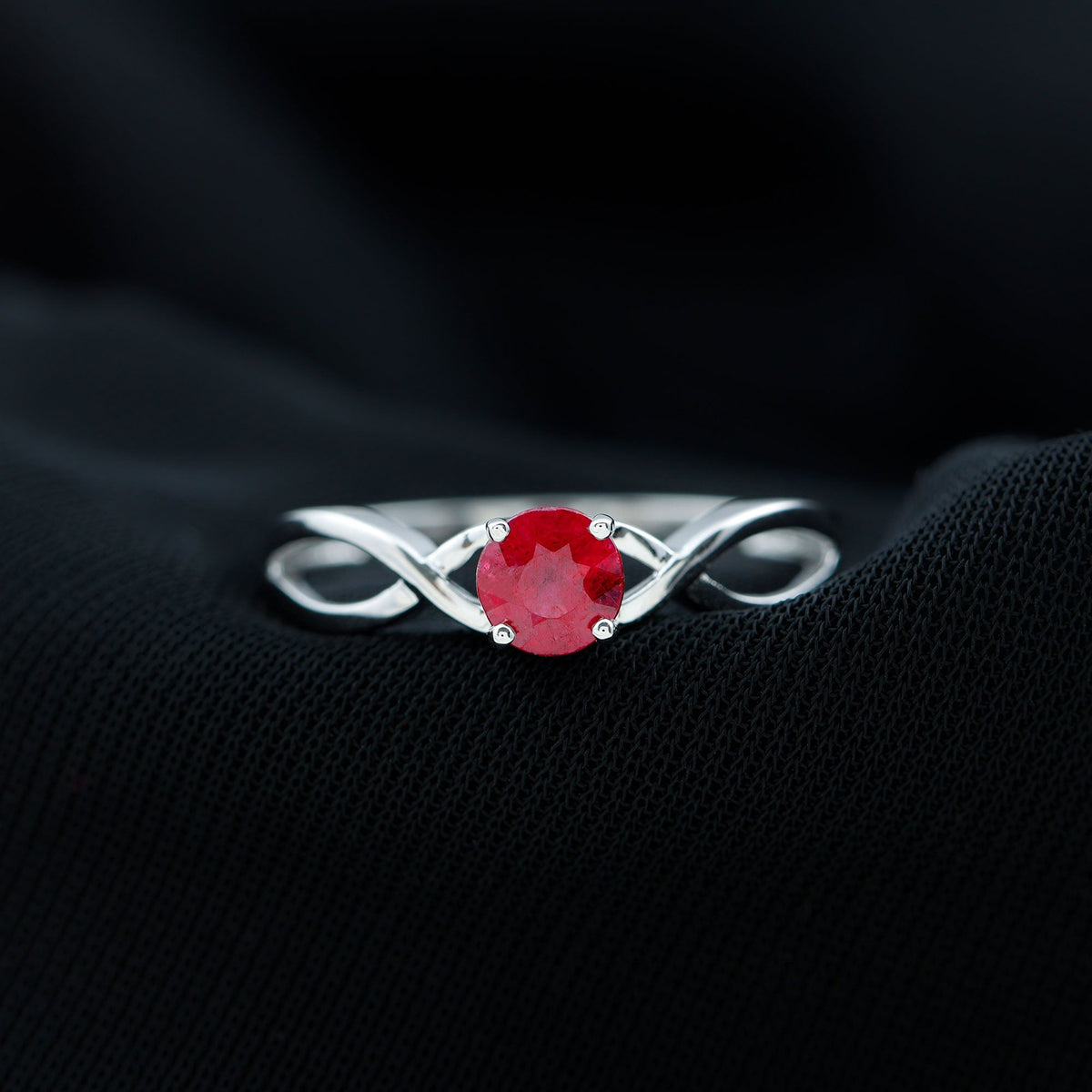 Natural 0.6 carat ruby promise ring with crossover shank from Rosec Jewels, showcasing a vibrant ruby gemstone and elegant band design.