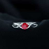 Natural 0.6 carat ruby promise ring with crossover shank from Rosec Jewels, showcasing a vibrant ruby gemstone and elegant band design.