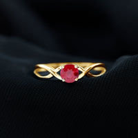 Natural 0.6 carat ruby promise ring with crossover shank from Rosec Jewels, featuring a vibrant red ruby gemstone and elegant design.