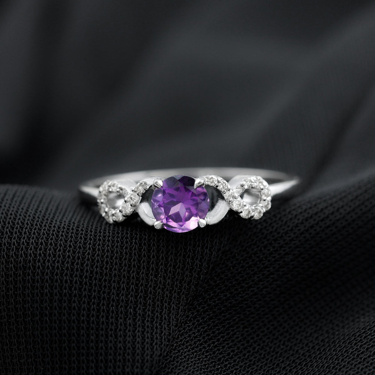 Natural amethyst engagement ring with diamond infinity knot detail from Rosec Jewels, showcasing a purple gemstone and intricate design.