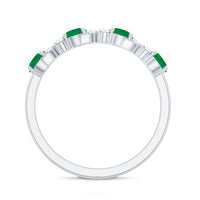Natural emerald and diamond half eternity ring by Rosec Jewels featuring a detailed band with sparkling gemstones and certificate.