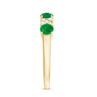 Natural emerald and diamond half eternity ring by Rosec Jewels featuring alternating emeralds and diamonds on a gold band.