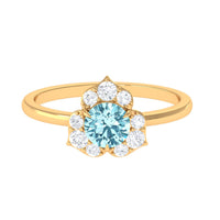 Rosec Jewels round aquamarine and diamond flower engagement ring featuring a central aquamarine gemstone with diamond accents.