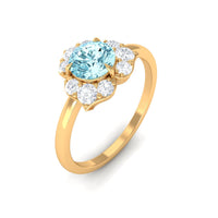 Real aquamarine and diamond flower engagement ring by Rosec Jewels featuring a round aquamarine centerpiece with diamond accents.