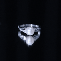 Genuine 7.4 carat freshwater pearl engagement ring with diamond crossover shank by Rosec Jewels, featuring a central pearl and sparkling diamonds.