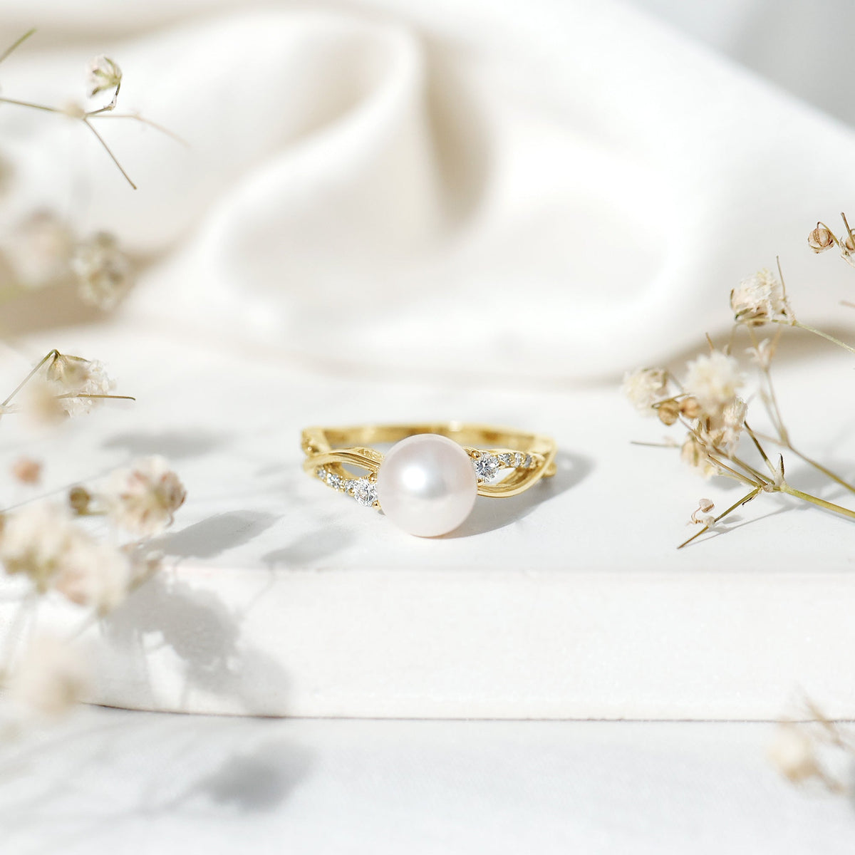 Genuine 7.4 carat freshwater pearl engagement ring with diamond crossover shank, featuring rose gold accents from Rosec Jewels.
