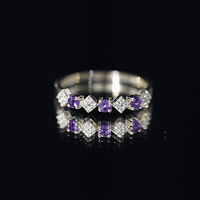 Real amethyst half eternity ring with diamonds for women, featuring yellow gold band and intricate gemstone setting.