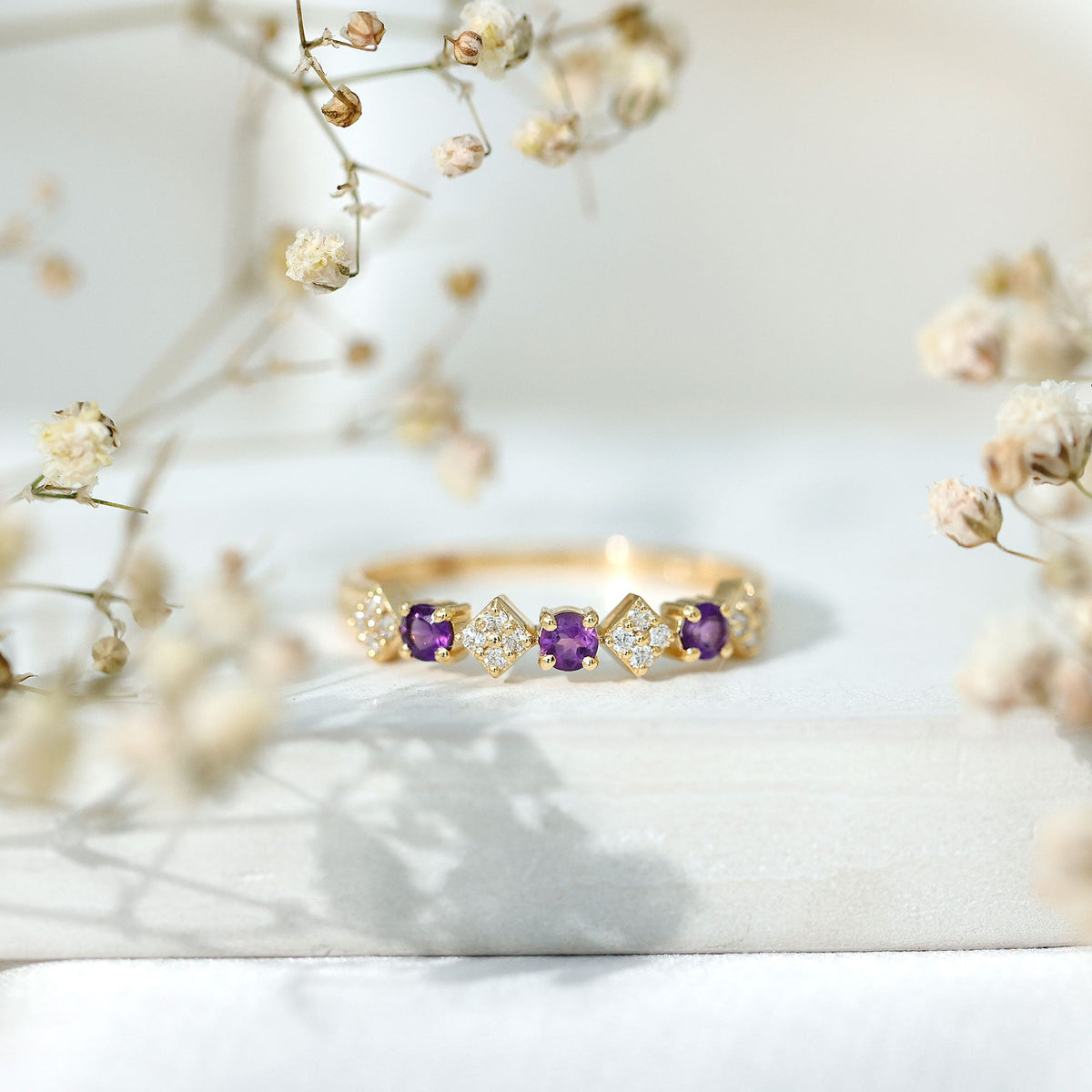Real amethyst half eternity ring with diamonds for women, showcasing a rosec Jewels ring featuring purple gemstones and sparkling accents.