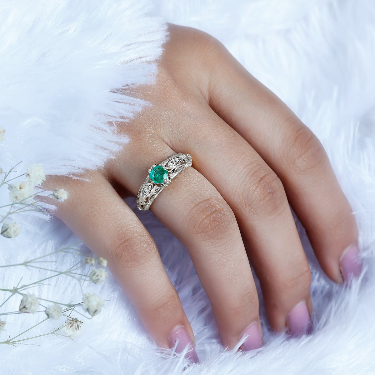 Antique-style engagement ring with natural emerald and diamond accents, crafted by Rosec Jewels, featuring intricate detailing.
