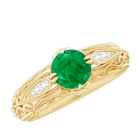 Antique-style engagement ring featuring a natural emerald and diamonds set in a detailed vintage design from Rosec Jewels.