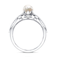 Cultured 2 Carat freshwater pearl solitaire engagement ring with diamond crossover shank by Rosec Jewels showing close-up of the ring.