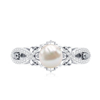 Cultured 2 Carat freshwater pearl solitaire engagement ring with diamond crossover shank by Rosec Jewels, close-up view of ring design