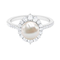 Freshwater pearl and diamond halo engagement ring by Rosec Jewels, featuring a central pearl surrounded by sparkling diamonds.