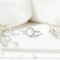 Freshwater pearl and diamond halo engagement ring by Rosec Jewels featuring a central pearl surrounded by sparkling diamonds.
