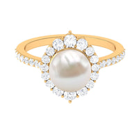 Freshwater pearl and diamond halo engagement ring by Rosec Jewels with intricate band and sparkling center stone.