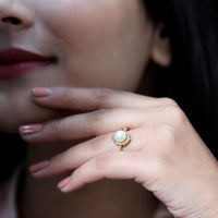 Freshwater pearl and diamond halo engagement ring from Rosec Jewels, featuring a central pearl surrounded by sparkling diamonds.
