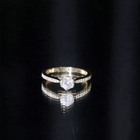 Rosec Jewels Lotus basket set cubic zirconia engagement ring with side stones, showcasing a detailed gold-tone ring with sparkling gemstones.