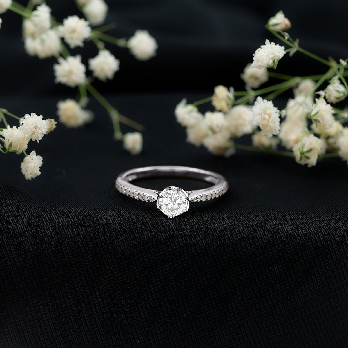 Rosec Jewels Lotus Basket Set engagement ring with cubic zirconia and side stones, featuring a detailed floral design and sparkling accents.